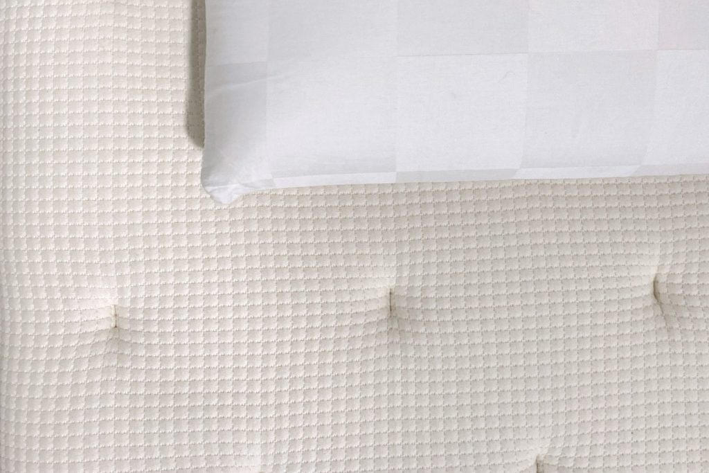 Almohada y colchón vistos desde arriba para decidir qué cambiar primero al mejorar el descanso